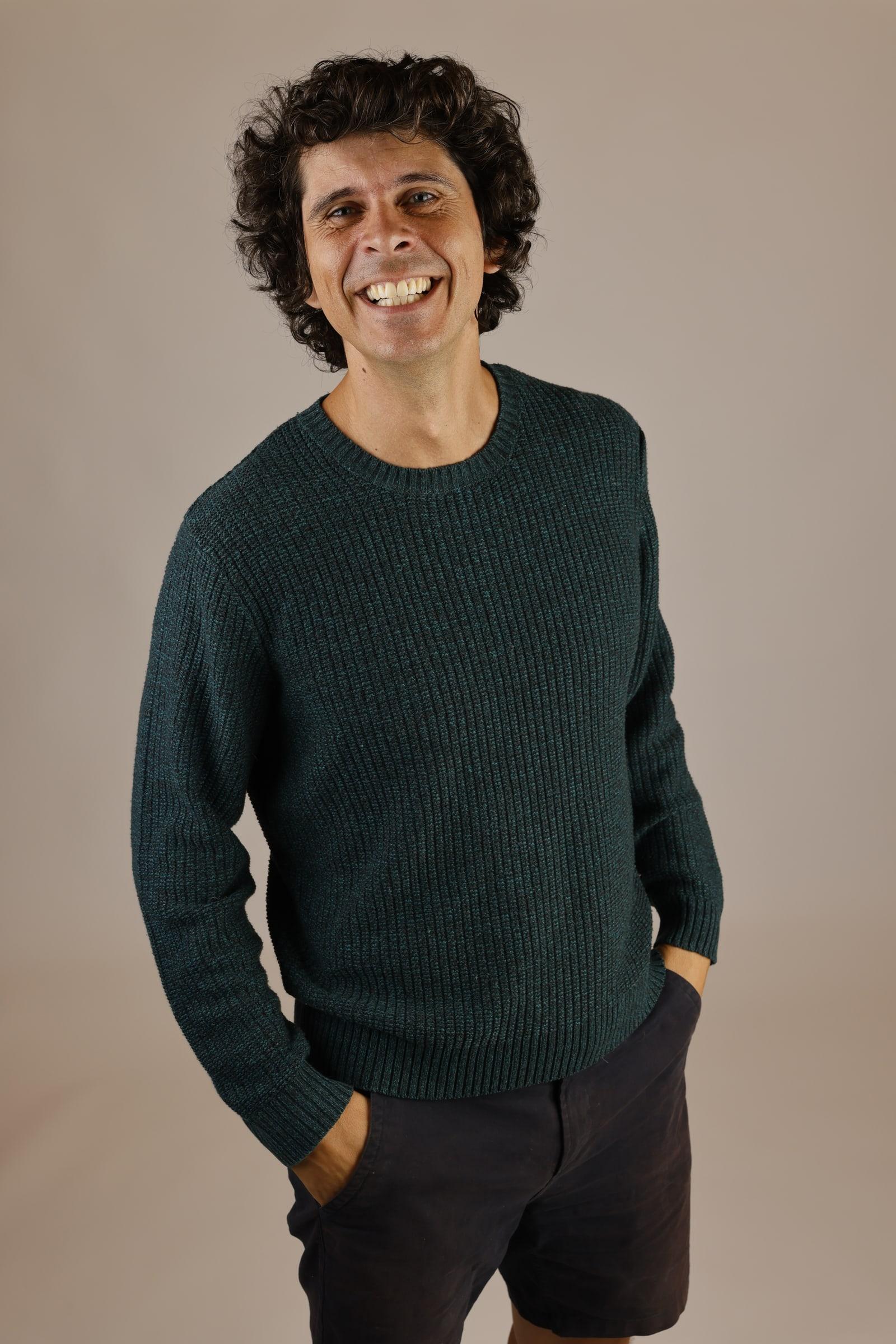 Andy Day, smiling, wearing a dark green jumper